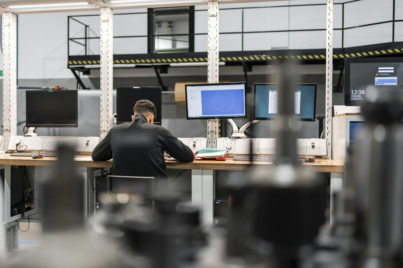 Engineer reviewing a design at CAD workstations